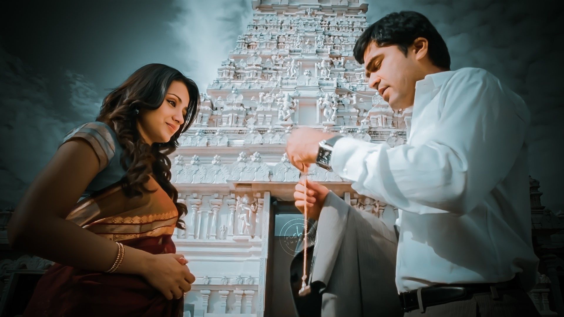Karthik reaching for Jessie's hand at the temple — the moment before the sentence ends